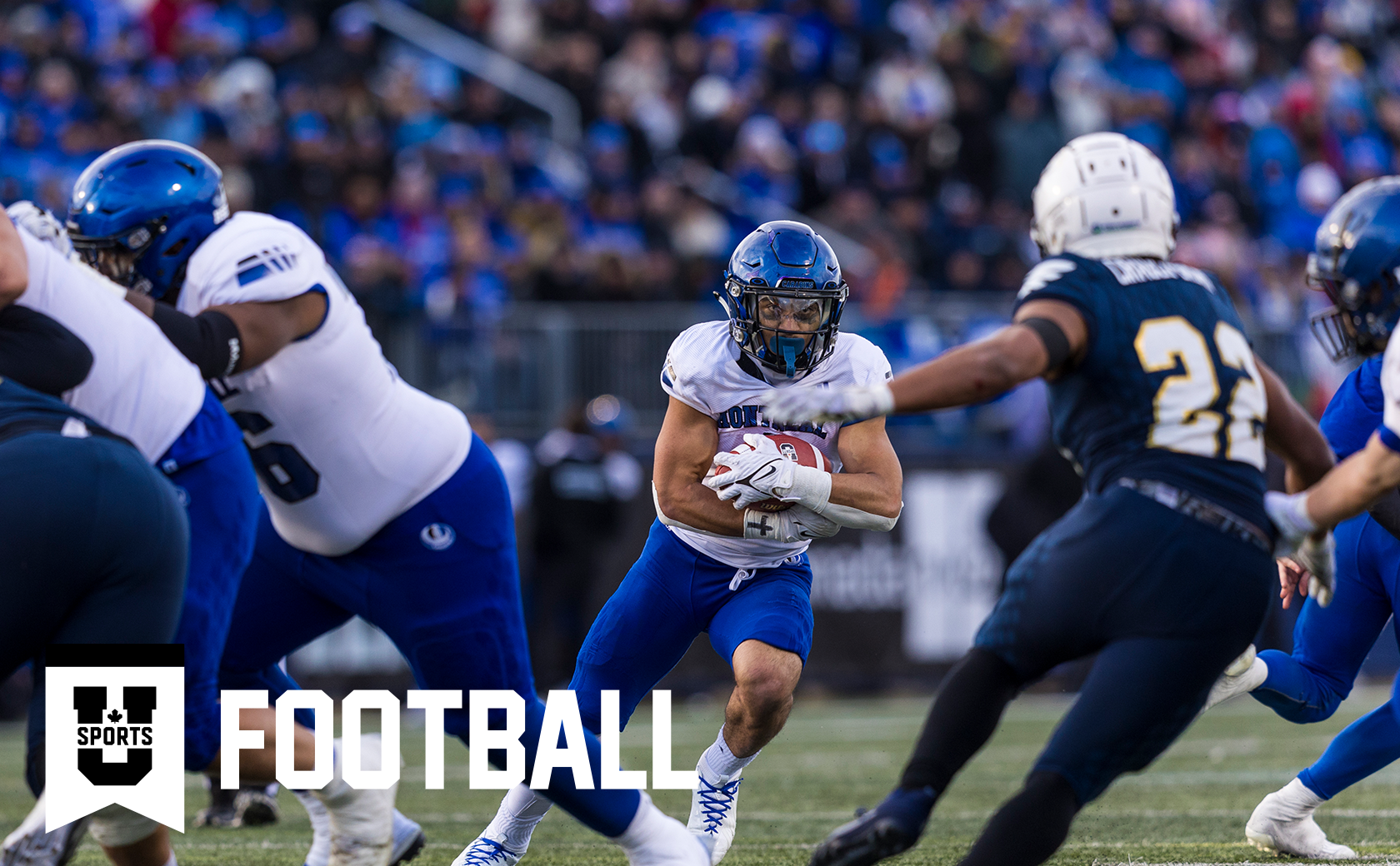 2024 Vanier Cup TicketsPhoto of the University of Montreal running back carrying the ball through a seam during the 2023 Canada Life Vanier Cup in Kingston, Ontario.